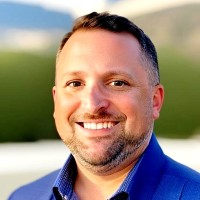Mike Wood, Talent Acquisition Analyst and Executive Community Leader at HR.com seen with a bright smile on his face